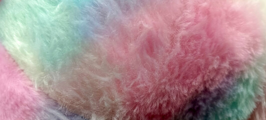Fototapeta premium Light pastel long fiber soft fur. Pink fur for background or texture. Shaggy blanket background. Fluffy fake textile fur.
