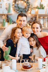 Beautiful big family in the kitchen with Christmas decor. to cook together.