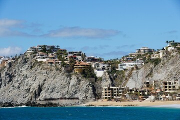 Fototapeta na wymiar The hill with luxury waterfront homes and resort hotels by the bay near Cabo San Lucas, Mexico