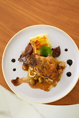 Roasted duck leg in prune sauce