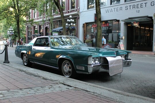 Classic green Cadillac Fleetwood Eldorado parked in Gastown, Canada