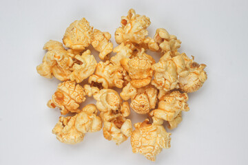Delicious popcorn with caramel on white background, top view