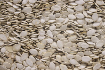 Bulk raw pumpkin seeds. Background of pumpkin seeds.