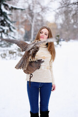 A girl and falcon in winter