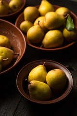 Ripe juicy pears in ceramic bowls