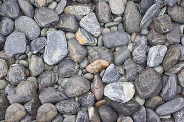 Light gray round stone on floor, in the park.
