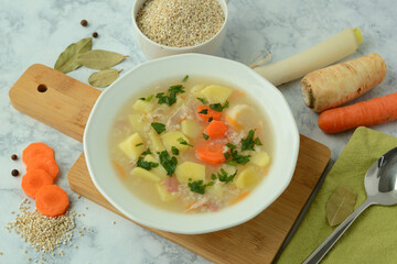 Krupnik, traditional Polish barley soup with vegetables in a bowl