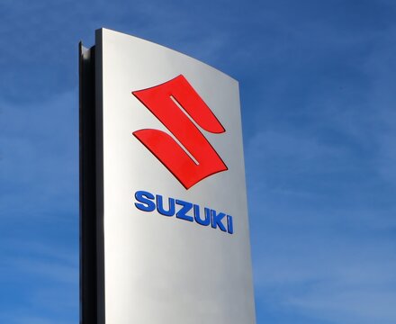 Udine, Italy. November 25 2019. Suzuki logo in the dealership of the area, against blue sky.  It is the symbol of the   japanese vehicle manufacturer. 
