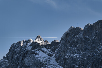 Two planes at the same time over the Zugspitze, snow covered mountain in the alps