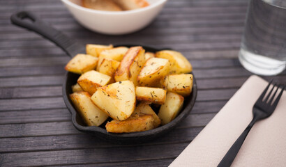 Spanish traditional appetizer patatas bravas on small cast iron skillet