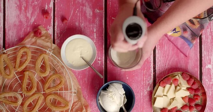 Flat lay food: chef mixes mascarpone with white chocolate