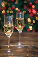 Two champagne glasses on wooden table