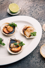 Scallop in sauce garnished with herbs