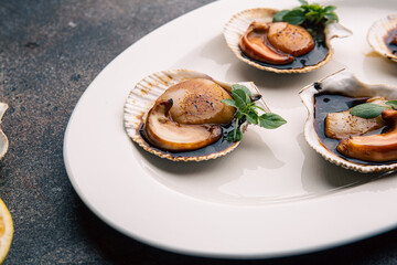Scallop in sauce garnished with herbs