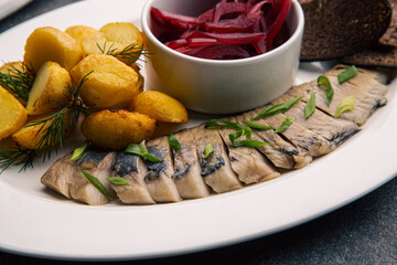 Herring with beetroot salad and baked potatoes