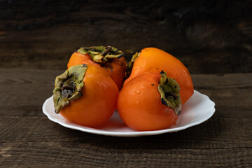 Persimmon fruit on a wooden table.