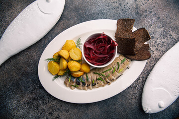 Herring with beetroot salad and baked potatoes
