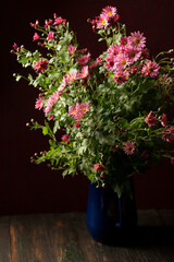 Fototapeta na wymiar A bouquet of beautiful pink chrysanthemums in a vintage vase