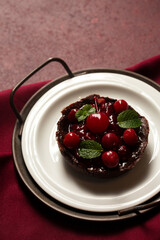 Chocolate dessert with cherries, close-up