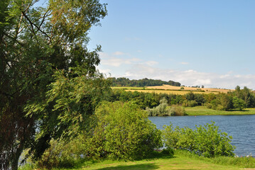 Fototapeta premium Landscape View of Lake and Hills on Sunny Day