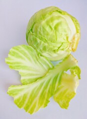 Fototapeta premium Cabbage head and leaves wrapped green-cabbage leafy greens vegetable food band gobi pata gobi brassica oleracea var. capitata closeup image stock photo 