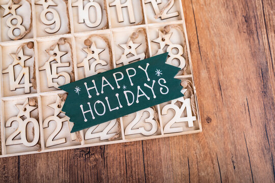 24 Days till Christmas vintage style wood calendar with happy Holiday written on wooden background ,Christmas eve time concept
