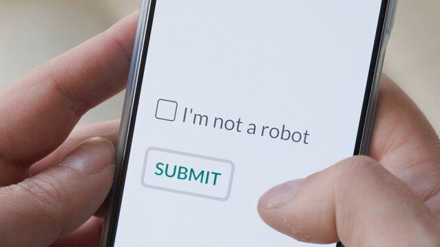 I m not a robot checkbox on phone screen with Submit button. Concept, technology, human check, verification, hands, close up, ai.