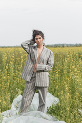An Asian model poses in a field of yellow flowers for a clothing brand, polyethylene is the main...