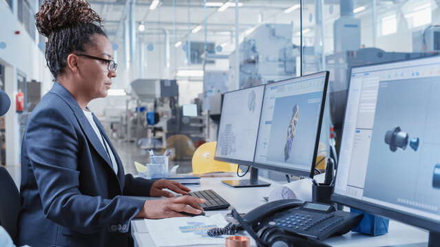 Factory Office Facility: Industrial Engineer Drafting Blueprints of a Heavy Industry Machine Parts on a Computer CAD Software. Modern Technological Industry 4.0 Research and Development Center.