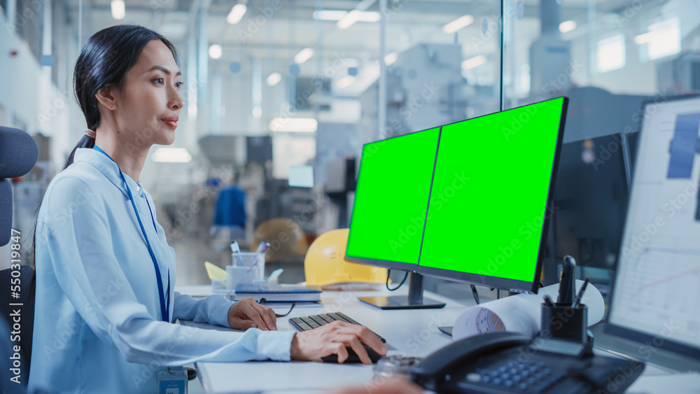 Poster Factory Office Facility: Industrial Engineer Drafting Blueprints of a Heavy Industry Machine Parts on a Computer CAD Software. One Computer Monitor Display is a Green Screen Mock Up Template.