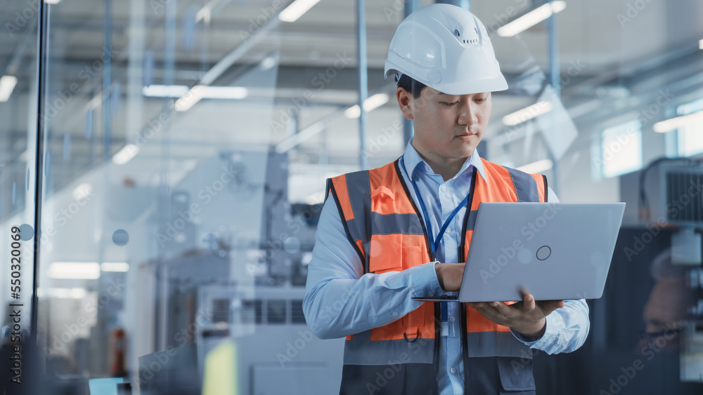 Aufkleber Research and Development Specialist Using Laptop to Operate a Heavy Industry Machine at a Factory. Asian Male Technician Configuring Industrial Machinery with the Help of Computer.