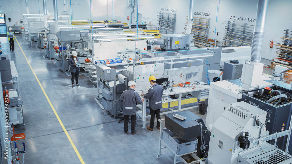 Poster Industrial Factory: Diverse Team of Engineers, Technicians, Professionals and Workers, Working on Production Plant, Optimizing CNC Machinery, Programming Machines, Planning Projects. Elevated Shot.