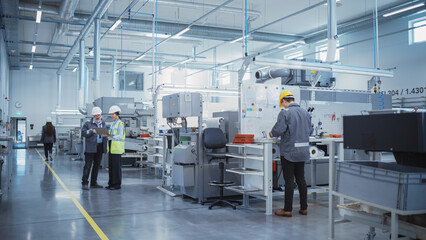 Industrial Factory: Team of Engineers, Technicians and Workers, Working on Production Plant,...