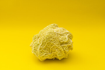 White cabbage lies on a yellow background