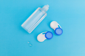 Subject photography of contact lenses on a blue background, with lens fluid