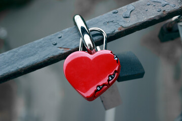 a heart-shaped padlock attached to a bridge, a promise of eternal love