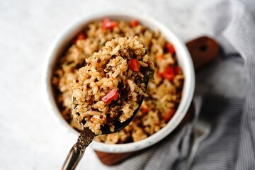 Quinoa brown rice pulao with red pepper served in a bowl- healthy eating concept