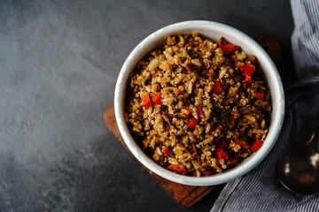 Quinoa brown rice pulao with red pepper served in a bowl- healthy eating concept