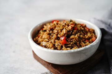 Quinoa brown rice pulao with red pepper served in a bowl- healthy eating concept