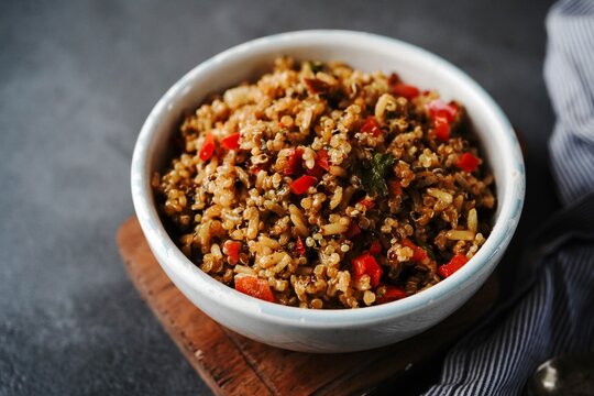 Quinoa brown rice pulao with red pepper served in a bowl- healthy eating concept