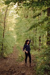A beautiful young woman walking in the forest