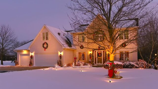Idyllic Holiday Home Decorated With Festive Outdoor Christmas Lighting and Snow, and ready for a family homecoming.