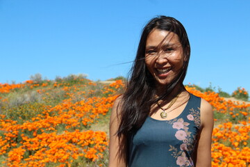 Smiling woman with hair on the face due to wind
