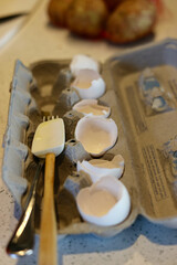 Broken eggshells in carton