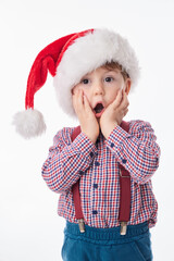 Funny surprised baby boy with tie and suspender and Santa Claus red hat, Christmas concept of lifestyle