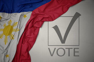 waving colorful national flag of philippines on a gray background with text vote. 3D illustration