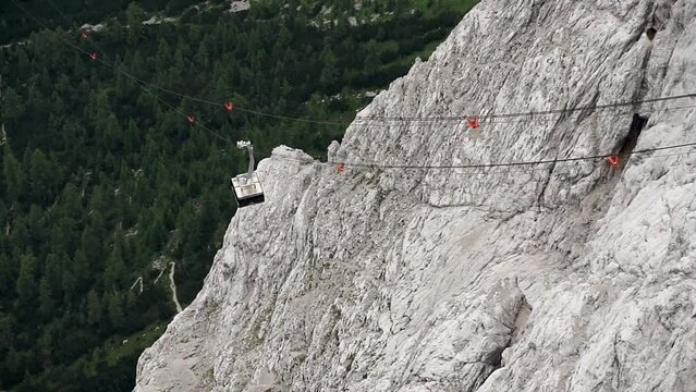 Gondola of the Zugspitz cable car floats through the low vegetation mountain world of the Alps
