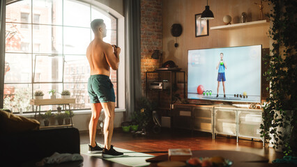 Home Training: Handsome Muscular Black Man Using Kettlebell, Exercising with Trainer via TV Online...