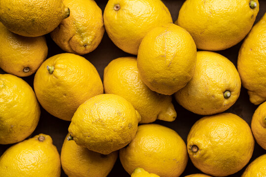 Pile of yellow lemons placed on table