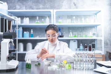Pharmaceutical factory woman worker in protective clothing operating production line in sterile...